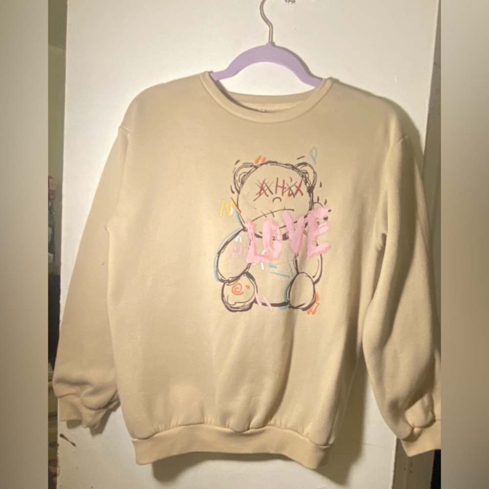 A beige bear love sweater